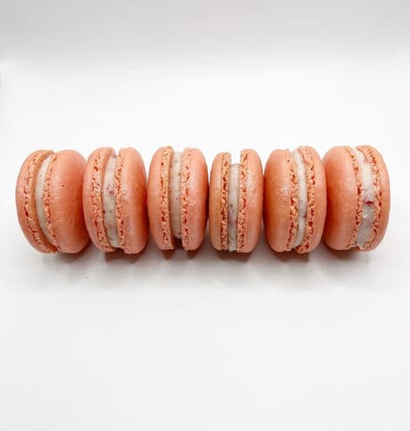 A row of pink macarons